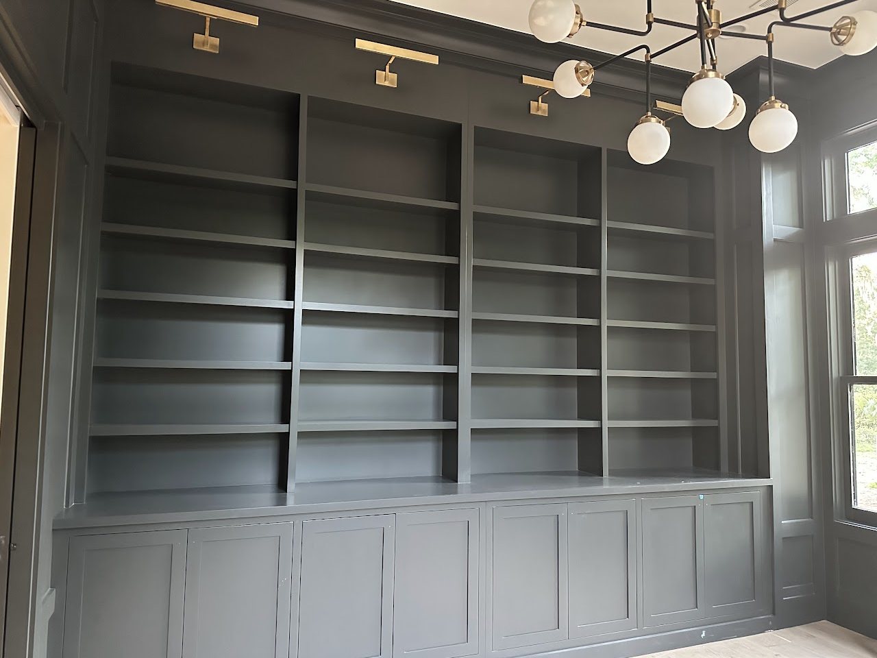 Floor to ceiling built in bookshelves with cabinets, by SV Construction
