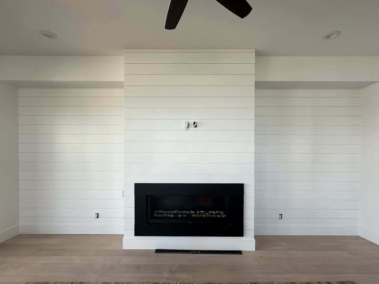 White shiplap fireplace wall, by SV Construction