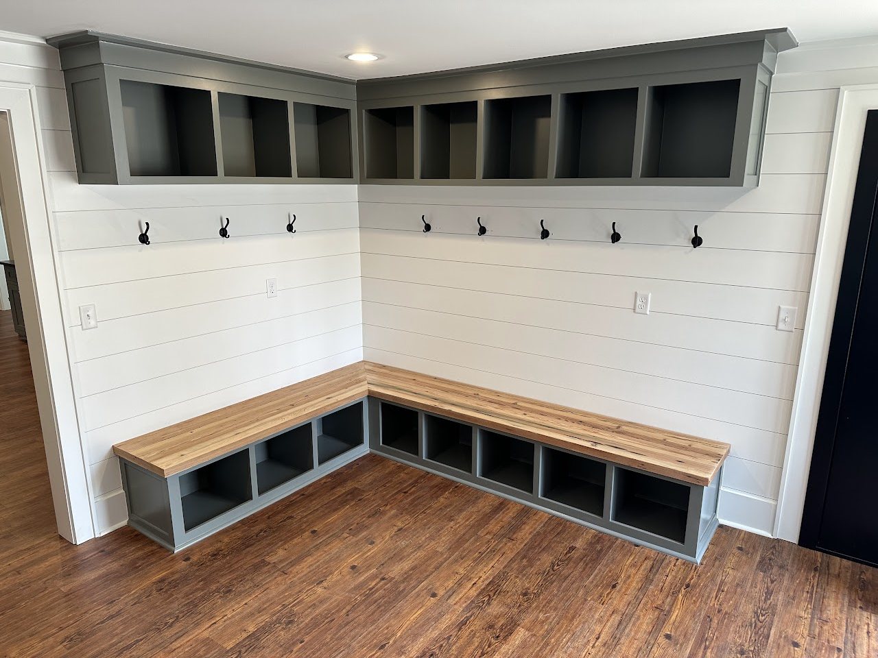 Mudroom corner bench with cubbies and coat hooks, by SV Construction