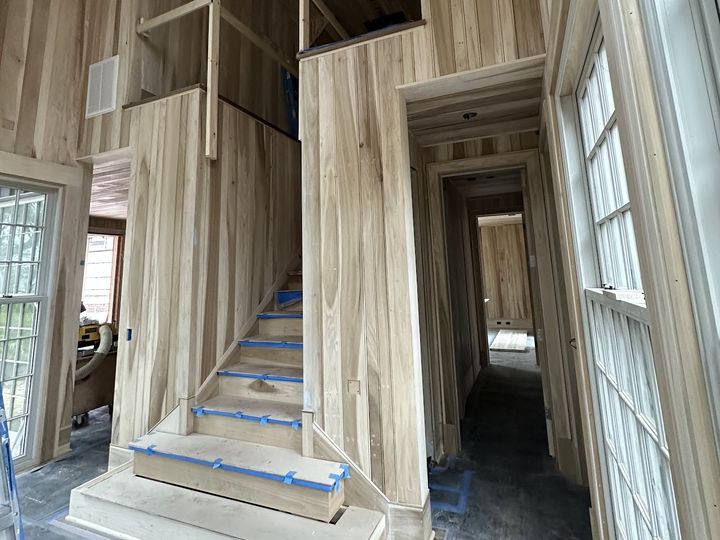Wood paneled stair hall under construction, by SV Construction