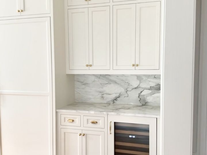 Beverage nook with marble backsplash and wine cooler, by SV Construction