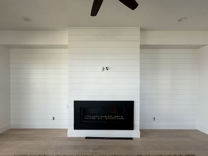 White shiplap fireplace wall, by SV Construction