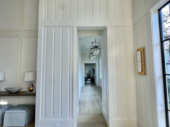 Vertical board paneling around a doorway, by SV Construction
