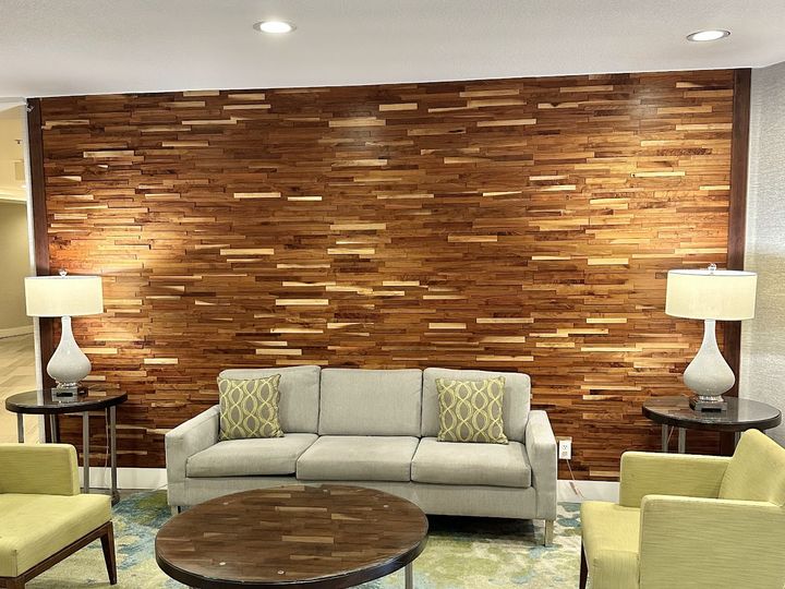 Wood plank accent wall in a lounge, by SV Construction