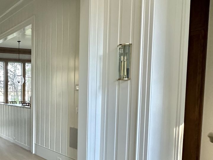 Vertical board paneling in a hallway, by SV Construction
