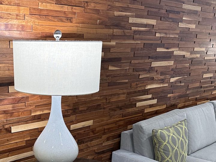 Wood plank accent wall behind a sofa, by SV Construction