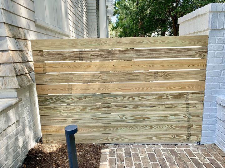 Horizontal board privacy fence between brick walls, by SV Construction