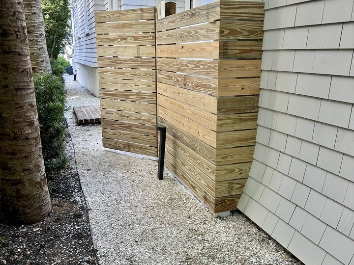 Horizontal board privacy screen beside a shingled house, by SV Construction