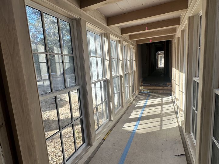 Window gallery with wood casings and ceiling beams, by SV Construction